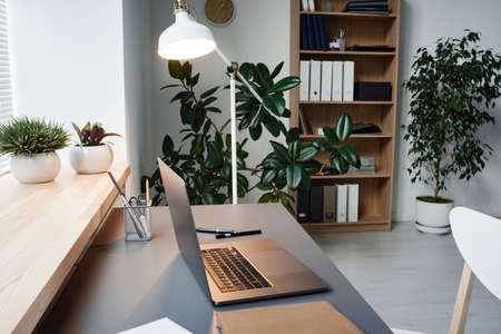 Image of modern workplace of business person with laptop on it at officeの写真素材
