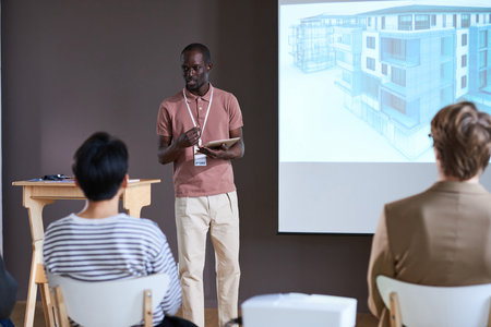 African young businessman using digital tablet presenting his project to business people during a presentationの写真素材