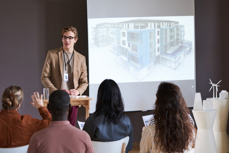 Young businessman talking about new technologies in architecture to business people during a semnarの写真素材
