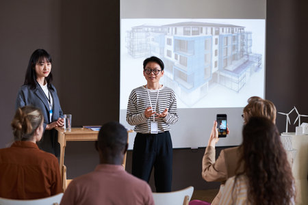 Asian successful businesswoman talking about the new architectural project during presentation for business peopleの写真素材
