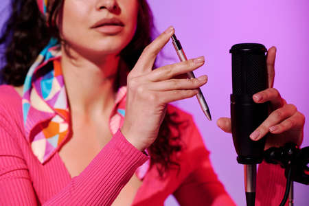 Selective focus cropped shot of young woman creating content for ASMR blog recording sound made with mechanical pencilの写真素材