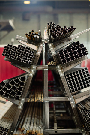 Vertical image of finished metal materials different diameters lying on pallet in workshopの写真素材