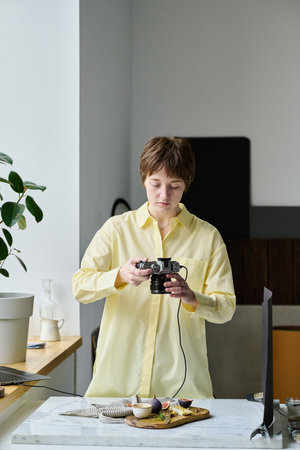 Professional photographer doing close-up pictures of still life using her photo cameraの写真素材