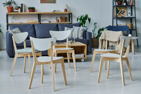 Horizontal image of chairs standing in circle preparing for therapy in the room