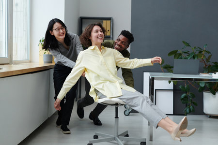 Group of young business people having fun together in modern office during breakの写真素材