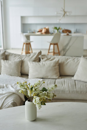 Vertical image of modern living room with beautiful flowers in vaseの写真素材