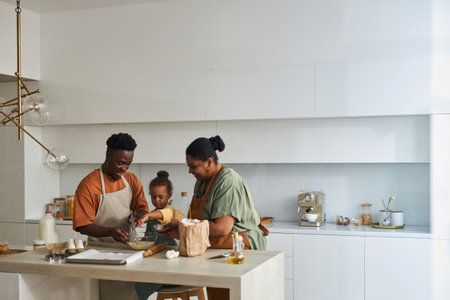 African American family of three baking together in the modern kitchenの写真素材