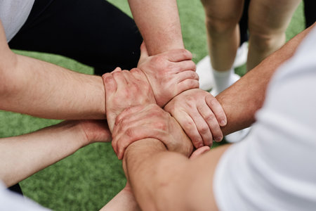 High angle view of cheerleader team holding hands and doing tricks together outdoorsの写真素材