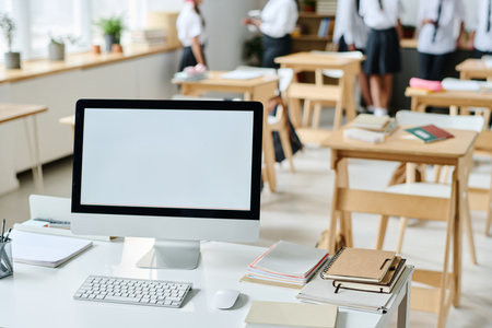 Workplace of teacher with computer for online studying in classroomの写真素材