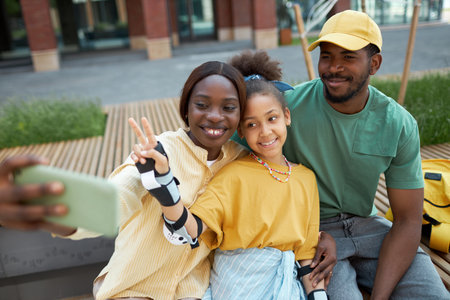 African American family making selfie portrait on smartphone during their walk outdoorsの写真素材