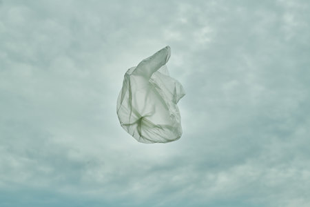 Top view of packet flying in the air against blue skyの写真素材