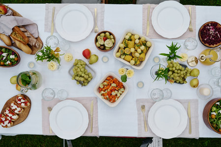 Top view of large table served with variety of appetizing homemade food such as vegetable stew,...