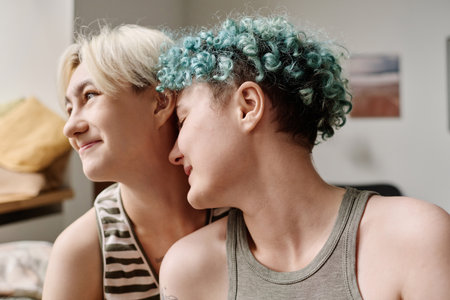 Young girls spending their time together at home and enjoying each otherの写真素材
