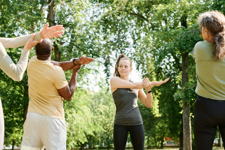Young coach training group of senior people in the parkの写真素材
