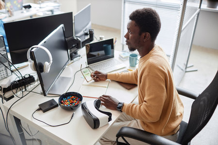 High angle view of African American programmer developing software in office