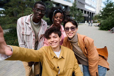 Selfie portrait of happy friends smiling at camera while walking in the cityの写真素材