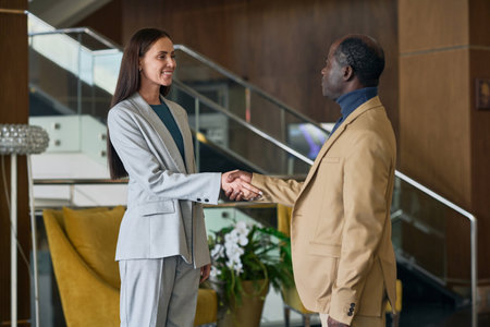 Business people shaking hands while having meeting in the hotelの写真素材