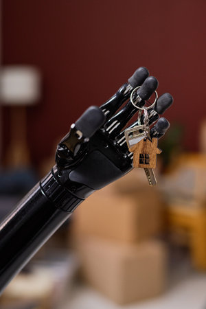 Vertical image of girl with prosthetic arm getting key from new houseの写真素材