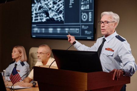 Politician pointing at screen and explaining situation in the country during military conference