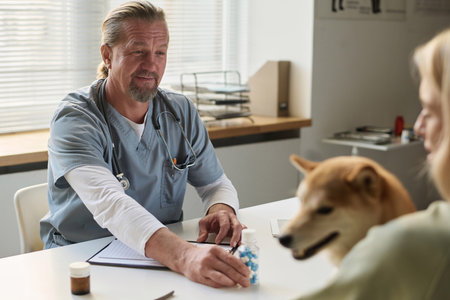 Professional veterinarian prescribing vitamins to dog after examination in vet clinic