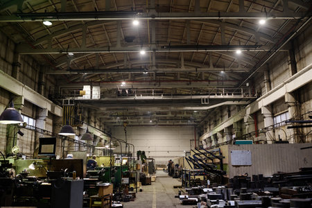 No people wide shot of old-fashioned industrial workshop interior equipped with various machines, copy spaceの写真素材