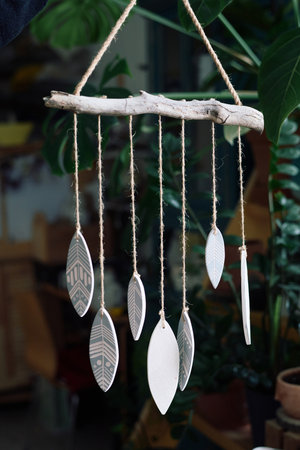 Vertical closeup no people shot of modern handmade ceramic wind chime
