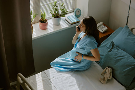 High angle shot of pregnant woman suffering from contractions while she informing doctorの写真素材