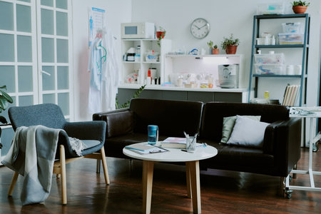 Cozy and spacious on call room divided into rest and kitchen zones fully equipped with furniture and medical stuffの写真素材