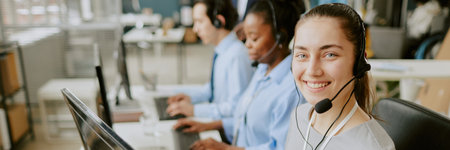 Website header demonstrating excited worker of call center sitting at her workplaceの写真素材