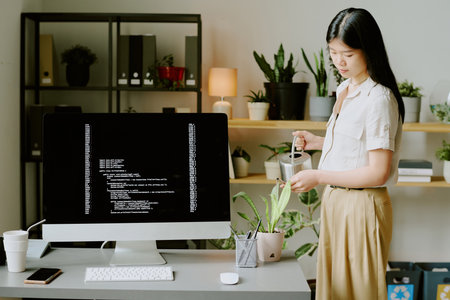 Medium long shot of young Asian office wearing elegant casual clothes standing in modern biophilic...