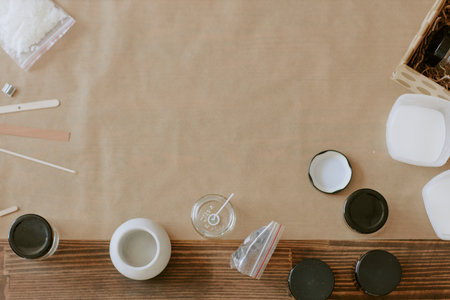 Crafting table displaying soap making materials organized, including molds, essential oils, and...