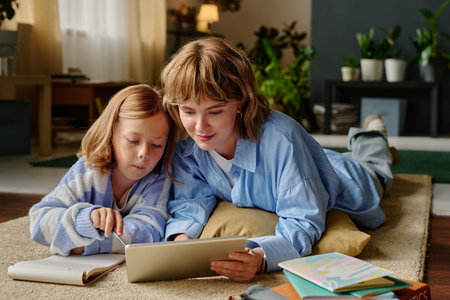 Mom and her lovely daughter laying on floor during online lesson