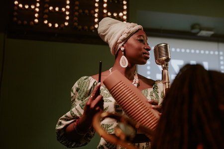 Medium low angle view shot of young African American woman singing jazz song and playing guiro