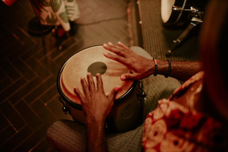 High angle view of unrecognizable man playing conga in Afro-Cuban jazz band