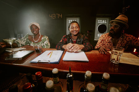 Group of African American male and female jazz musicians spending nice evening together in local barの写真素材