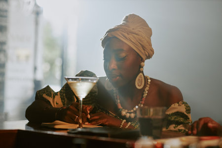 Medium closeup of young Black female jazz musician writing new song while spending evening in local barの写真素材