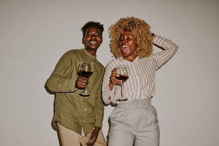 drunk couple having fun together, they drinking wine and laughing out loudの写真素材