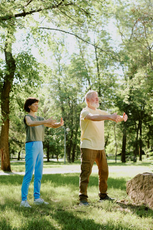 Senior Couple breathing in fresh summer air in park during meditation practiceの写真素材