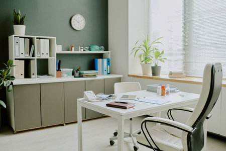 Office interior with minimalist decor featuring organized shelves, a desk with office supplies,...