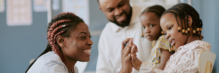 Smiling woman engaging with child while others observe in classroom environment, showcasing connection and interaction. Suitable for educational and family-oriented contextsの写真素材