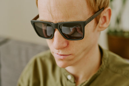 Medium close up of focused male face with black glasses,の写真素材