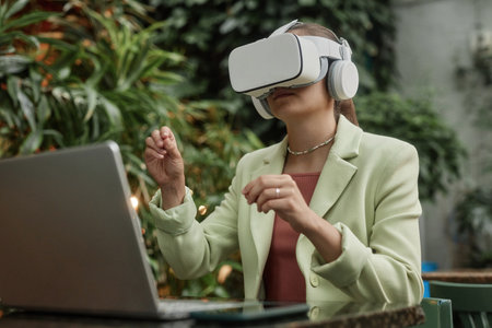 Low angle shot of young woman testing new VR goggles while chilling in eco cafeの写真素材