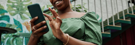 Website Banner with low angle shot of beaming woman enjoying chatting on social networkの写真素材