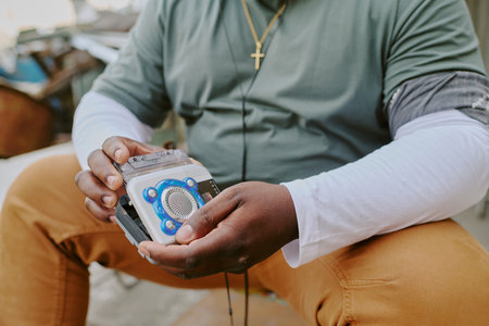 Unrecognizable male hands holding old fashioned tape recorderの写真素材