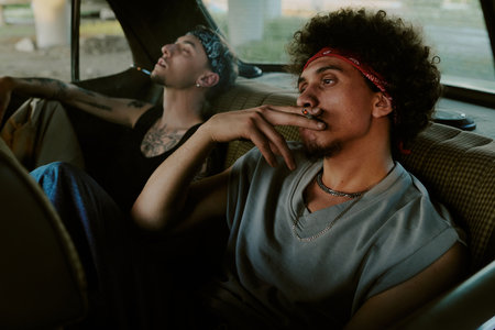 Biracial dudes chilling out in car, they smoking cigarettesの写真素材