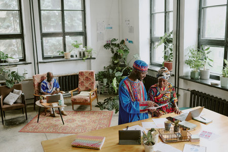 High angle shot of African American developers working in modern office of successful it companyの写真素材