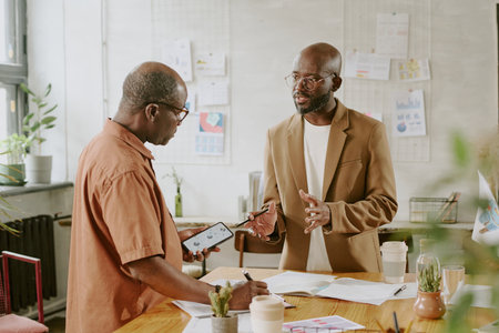 African American coworker telling about last analytical research in officeの写真素材