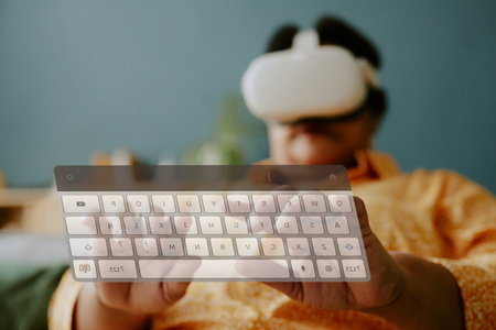 Low angle shot of senior woman with headset typing on transparent VR presentationの写真素材