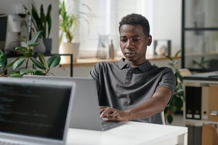 African American programmer writing codes in modern officeの写真素材