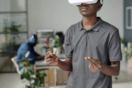 African American game developer gesticulating while enjoying VR gameの写真素材